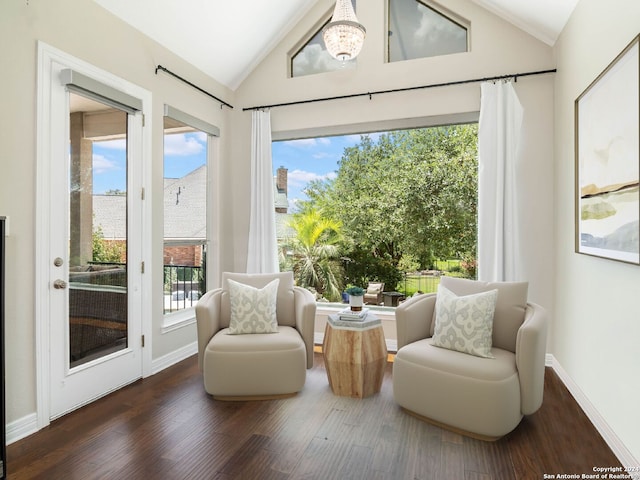 living area featuring high vaulted ceiling, dark wood-type flooring, and a healthy amount of sunlight