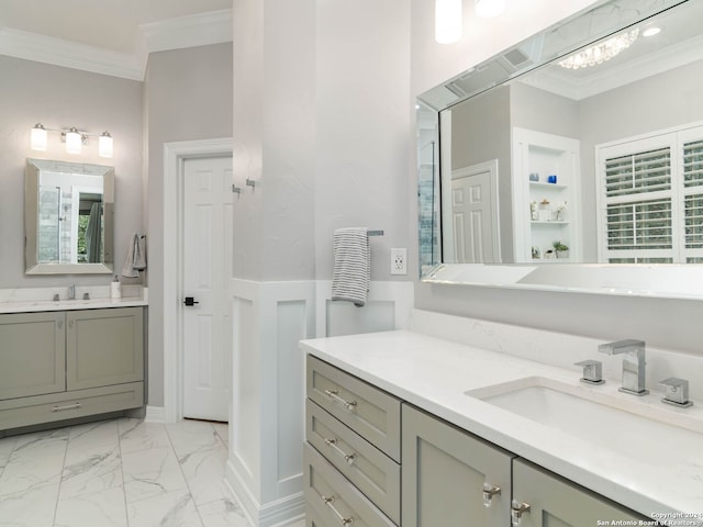 bathroom featuring built in shelves, vanity, and crown molding