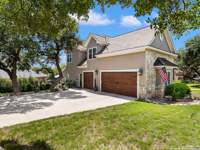 view of front of house with a front yard and a garage