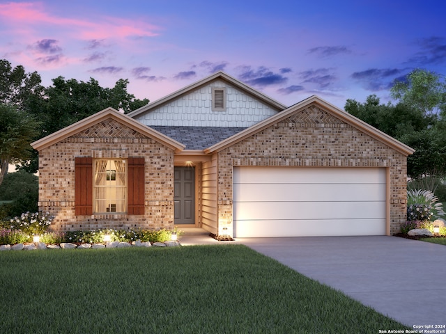 view of front of property with a garage and a lawn