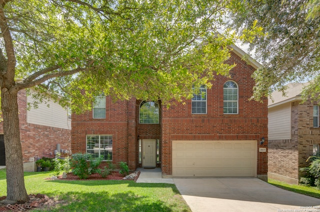 view of front facade with a front yard and a garage