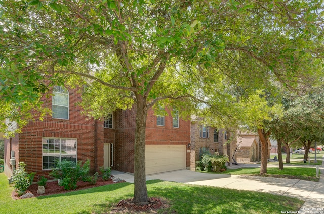 view of front of property with a front yard and a garage