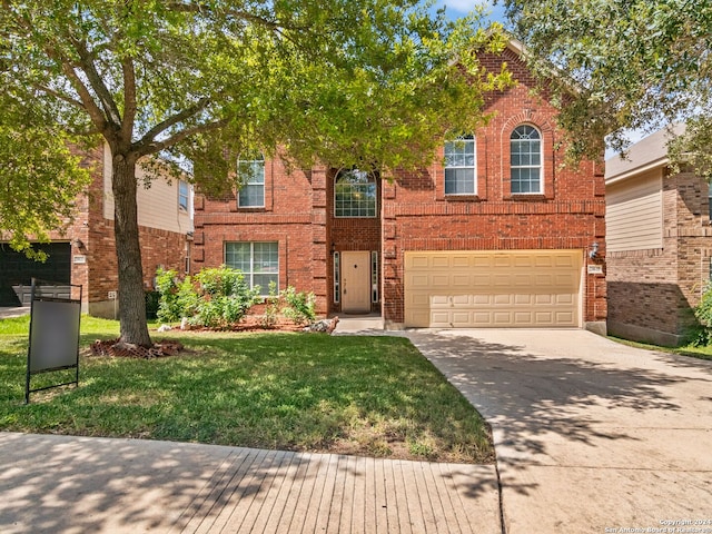 view of front of house with a garage and a front yard