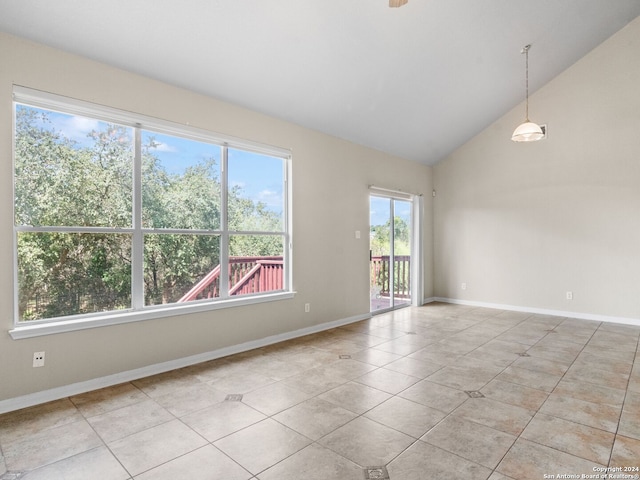 tiled empty room with vaulted ceiling