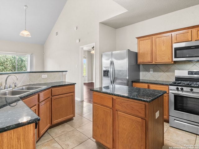 kitchen with sink, decorative light fixtures, a center island, and appliances with stainless steel finishes