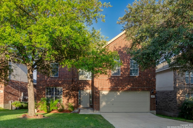 view of front of house with a garage and a front yard