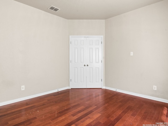 spare room featuring dark hardwood / wood-style flooring