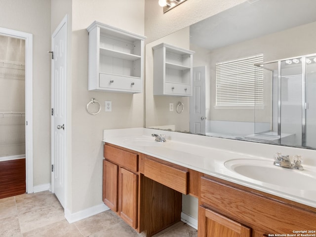 bathroom featuring vanity and a shower with door