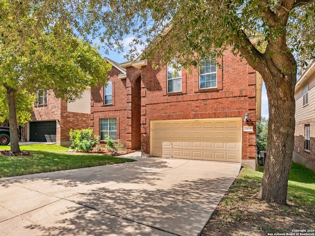 view of front of home with a garage and a front lawn