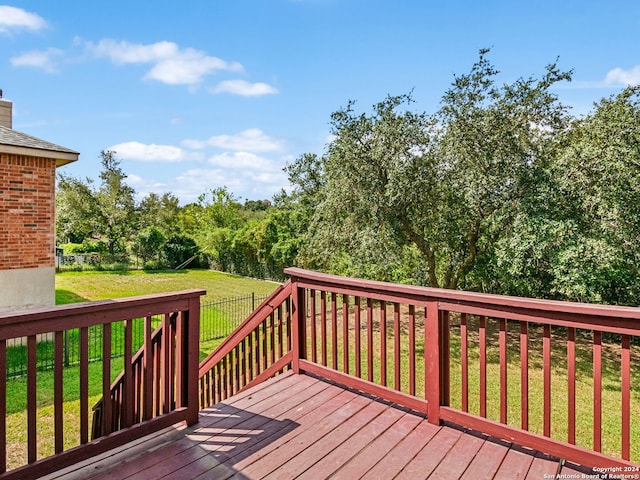 wooden terrace with a lawn