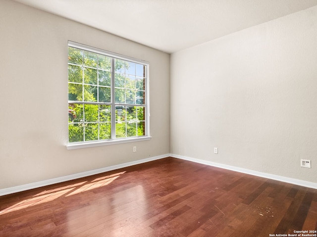 unfurnished room with dark hardwood / wood-style floors