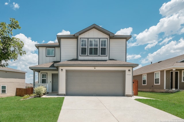 front of property featuring a front lawn and a garage