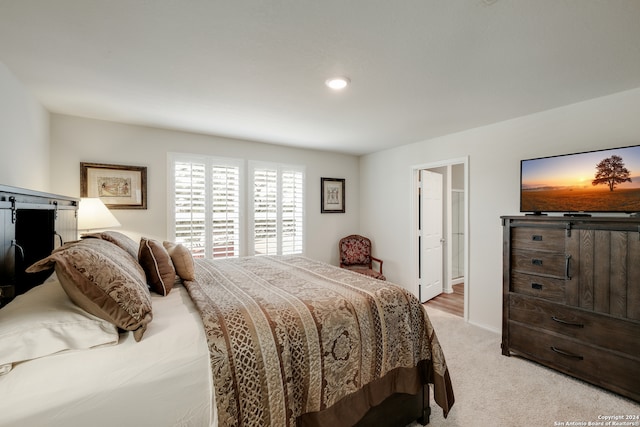 carpeted bedroom featuring connected bathroom