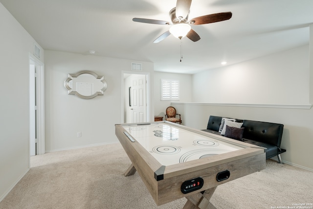 game room featuring light carpet and ceiling fan