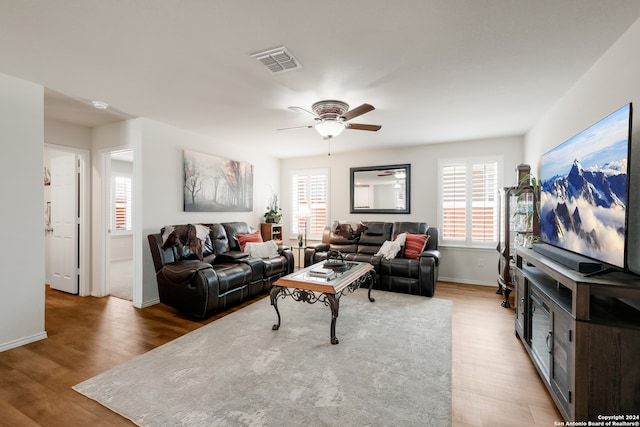 living room featuring ceiling fan and hardwood / wood-style floors