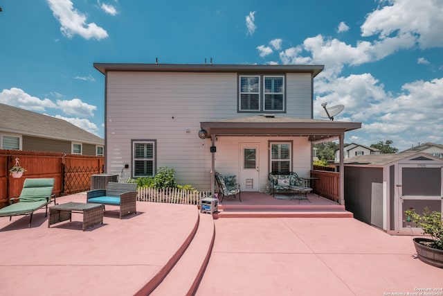 rear view of house featuring a patio area and a shed