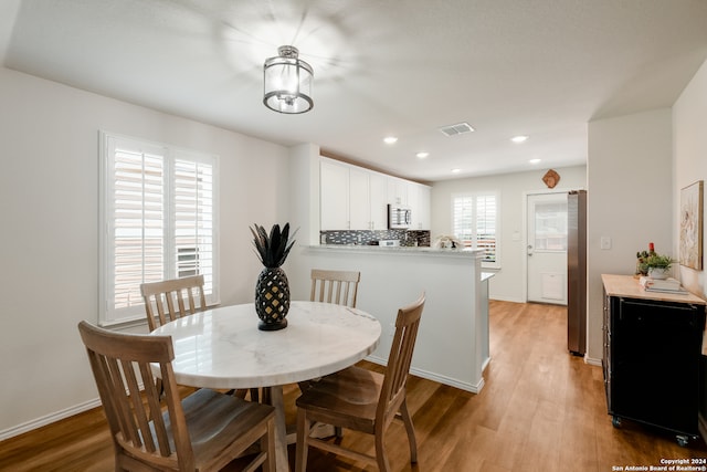 dining space featuring light hardwood / wood-style flooring