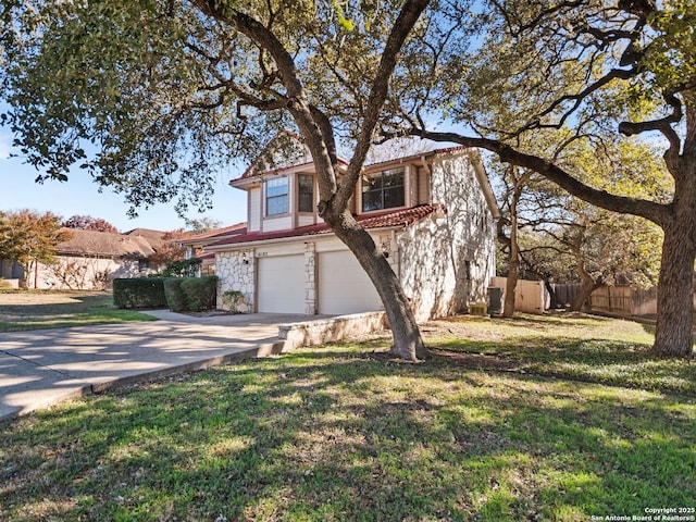 view of front of house featuring a garage and a front lawn