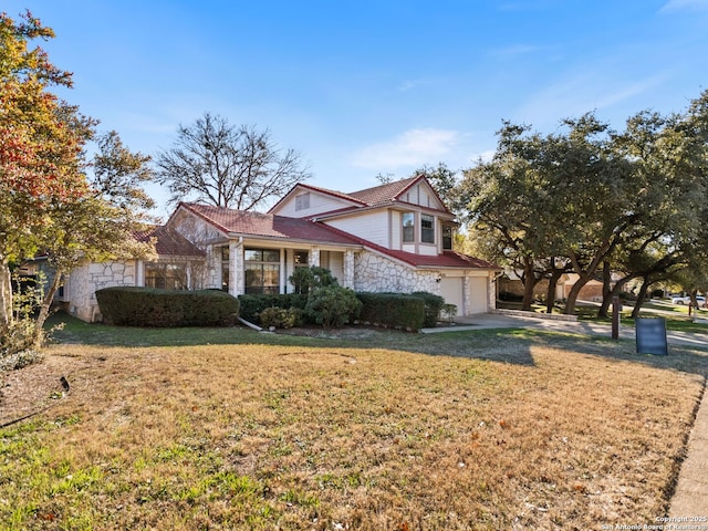 view of front of house featuring a garage and a front lawn