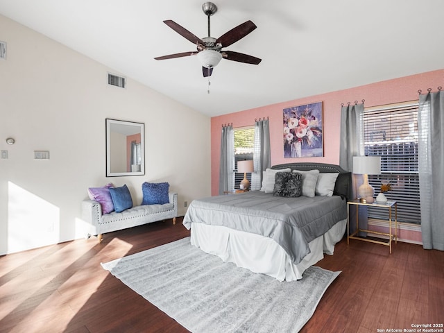 bedroom with ceiling fan, dark hardwood / wood-style flooring, and vaulted ceiling