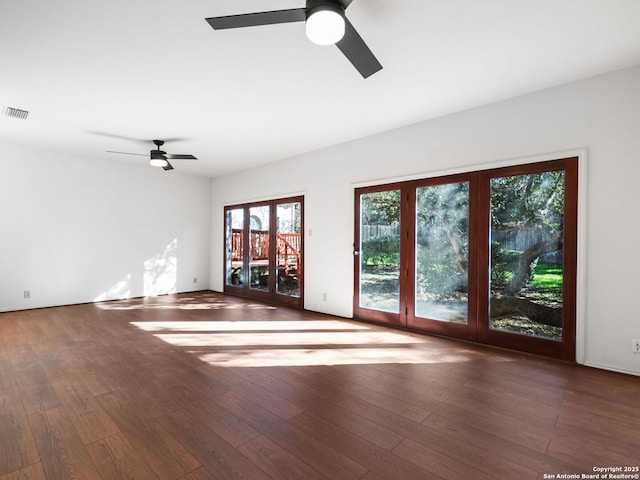 unfurnished living room featuring dark hardwood / wood-style floors and ceiling fan