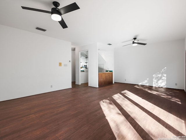 unfurnished living room featuring dark hardwood / wood-style flooring and ceiling fan