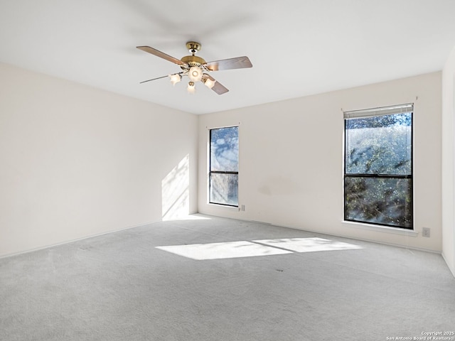 carpeted empty room with ceiling fan