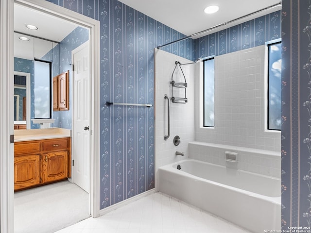 bathroom with vanity and tiled shower / bath