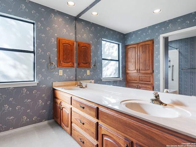 bathroom with vanity and a shower