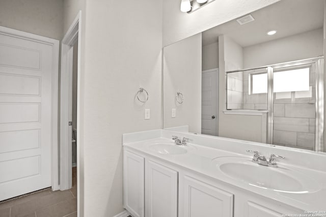 bathroom with double sink vanity and tile patterned floors