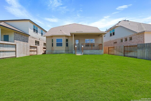 back of house with a lawn