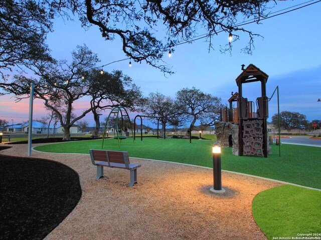 view of home's community featuring a lawn and a playground