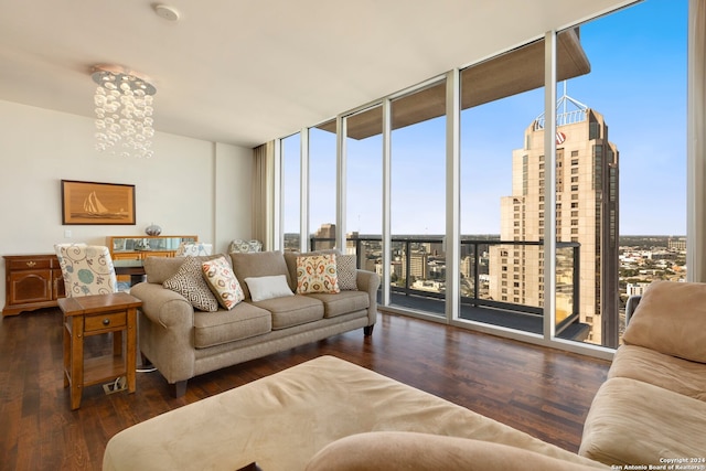 living room featuring expansive windows, a chandelier, and dark wood-type flooring