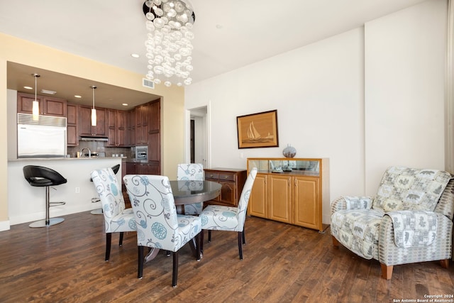 dining space featuring a chandelier and dark wood-type flooring