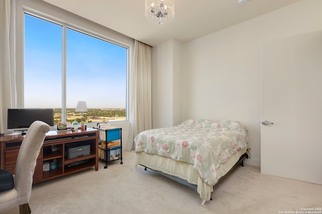 bedroom featuring light carpet and multiple windows