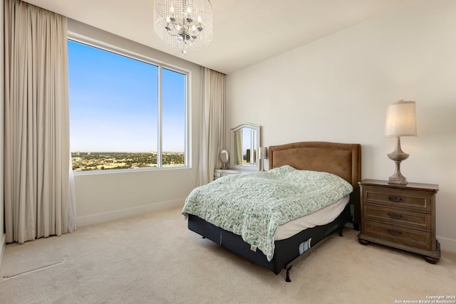 bedroom featuring a chandelier and light colored carpet