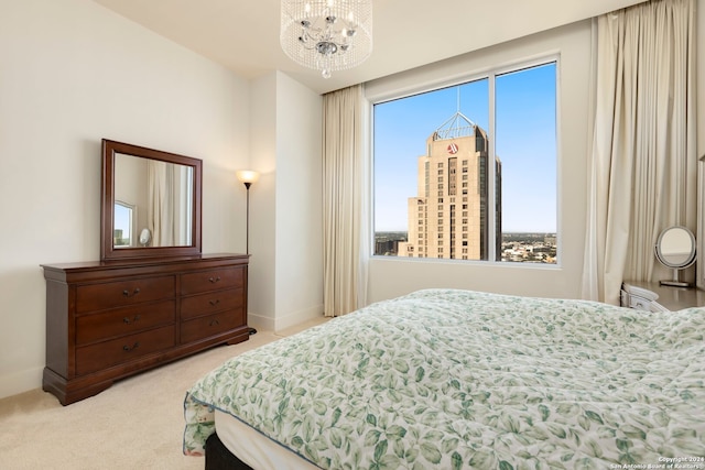 carpeted bedroom with a chandelier