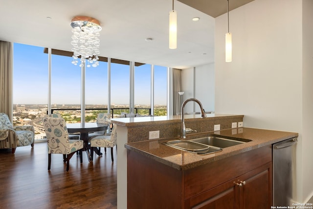 kitchen featuring expansive windows, dark stone countertops, dark hardwood / wood-style floors, sink, and decorative light fixtures