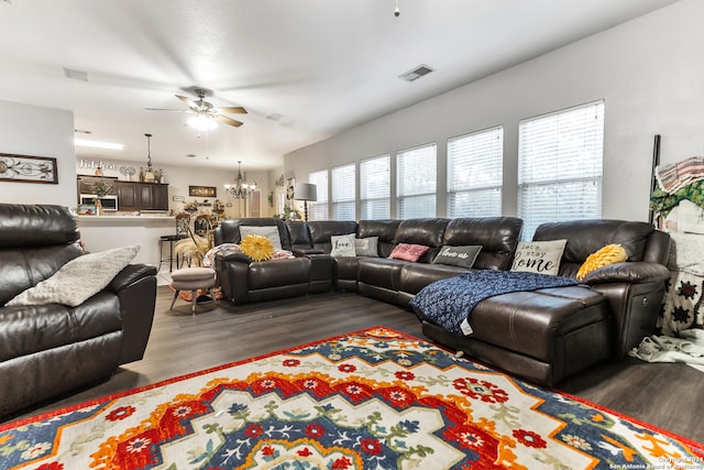 living room featuring ceiling fan with notable chandelier, a healthy amount of sunlight, and hardwood / wood-style flooring