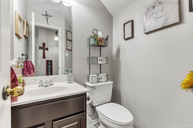 bathroom featuring toilet, tile patterned floors, and vanity