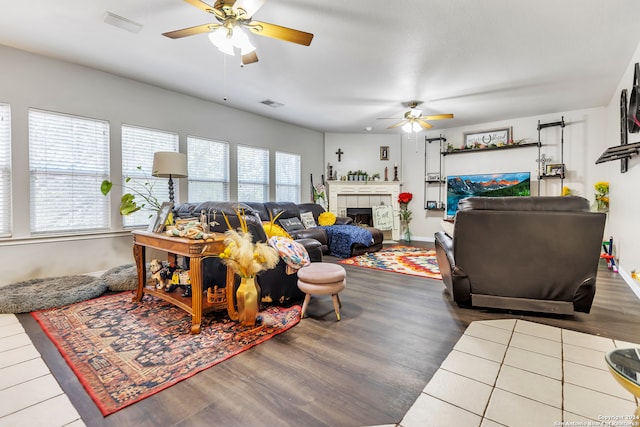 living room with a fireplace, hardwood / wood-style floors, and ceiling fan