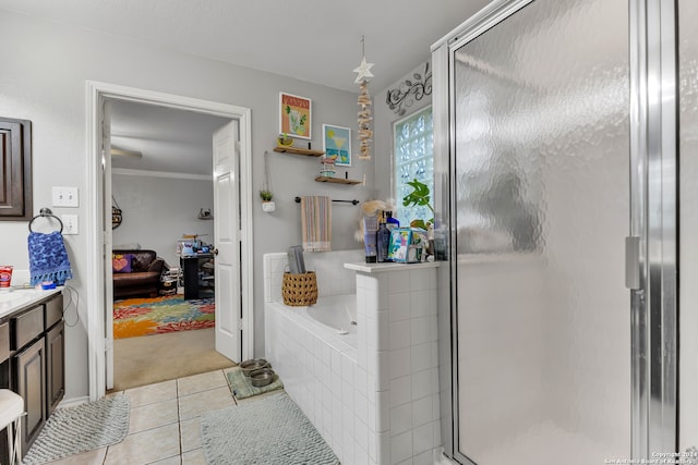 bathroom with tile patterned floors, vanity, plus walk in shower, and crown molding