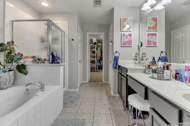 bathroom featuring dual bowl vanity, separate shower and tub, and tile patterned flooring