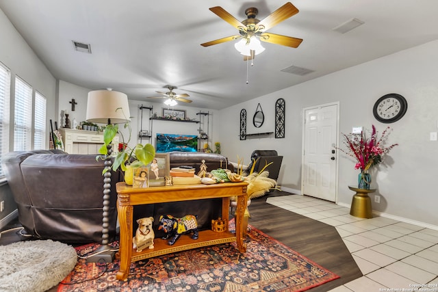 tiled living room featuring ceiling fan