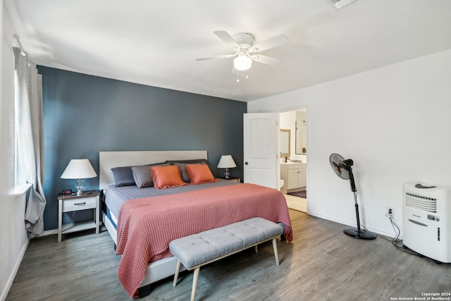 bedroom with dark wood-type flooring, ceiling fan, and ensuite bath