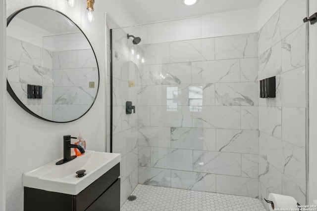 bathroom with vanity and a tile shower