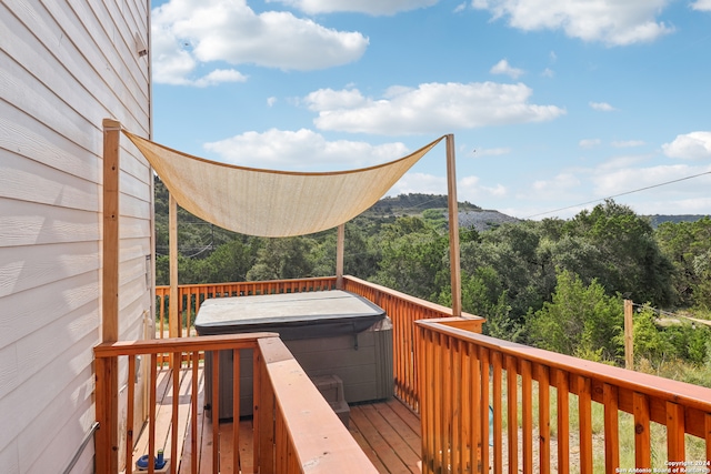 wooden deck featuring a hot tub