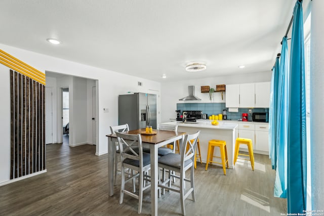 dining area featuring sink and hardwood / wood-style floors