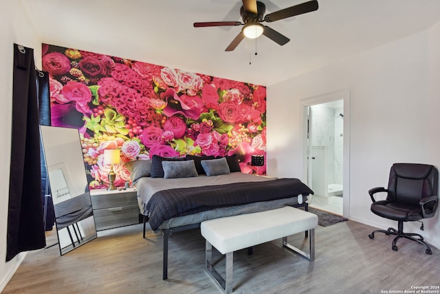 bedroom with light wood-type flooring, ceiling fan, and ensuite bath