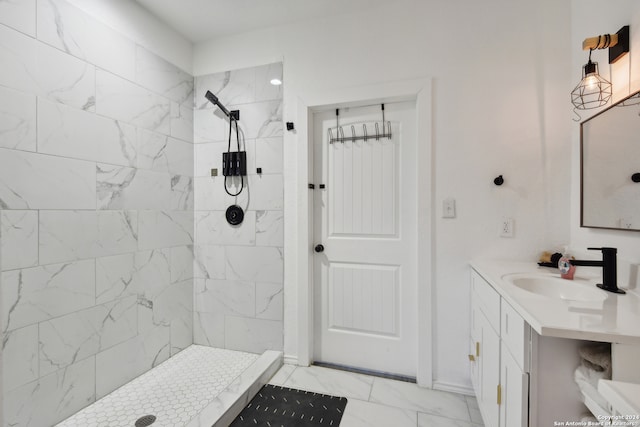 bathroom featuring vanity and tiled shower